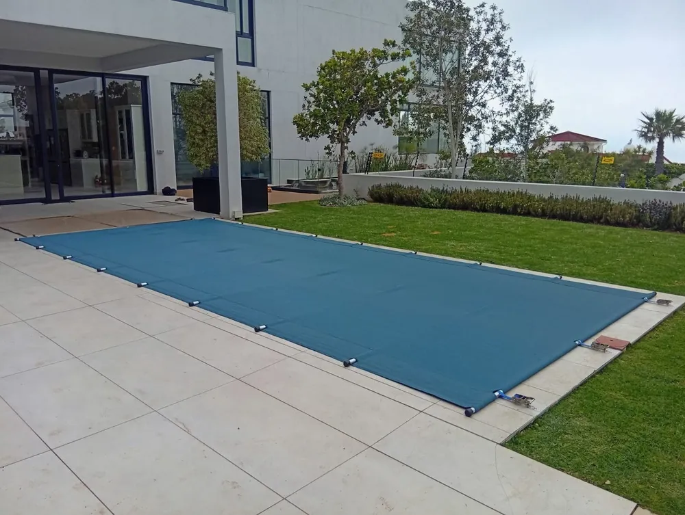 Pool cover fitted beside a garden lawn